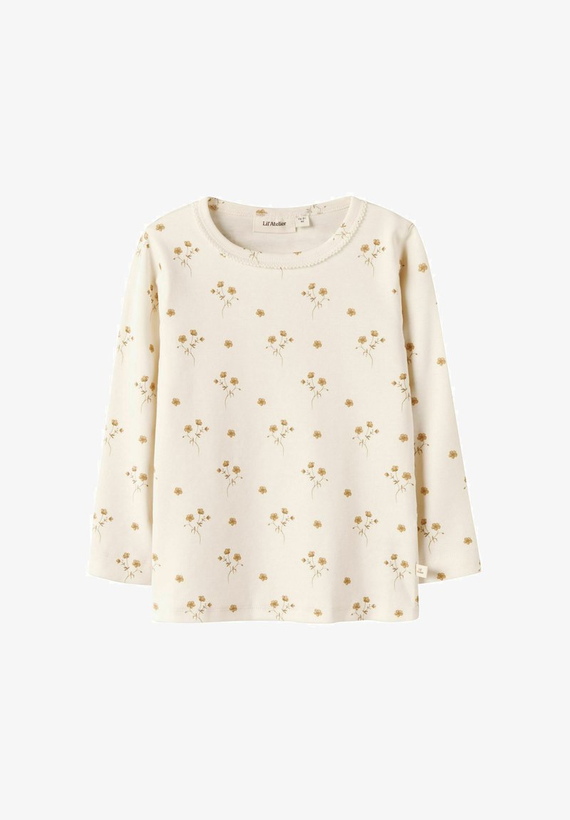 Camicia a maniche lunghe color crema con piccolo motivo floreale giallo, scollatura rotonda e tessuto morbido, progettata per bambini.