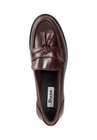 Burgundy leather moccasin with a smooth finish, featuring a flat sole, prominent top seam, and decorative tassel accents. Brand label visible inside.