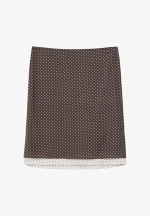 Brauner knielanger Rock mit kleinem weißem Rautenmuster und weißem Innenfutter, das am Saum sichtbar ist.