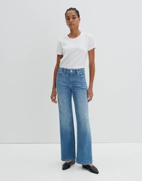 High-waisted, light blue jeans with a straight leg design, made of denim, paired with a fitted white cotton T-shirt and black shoes.