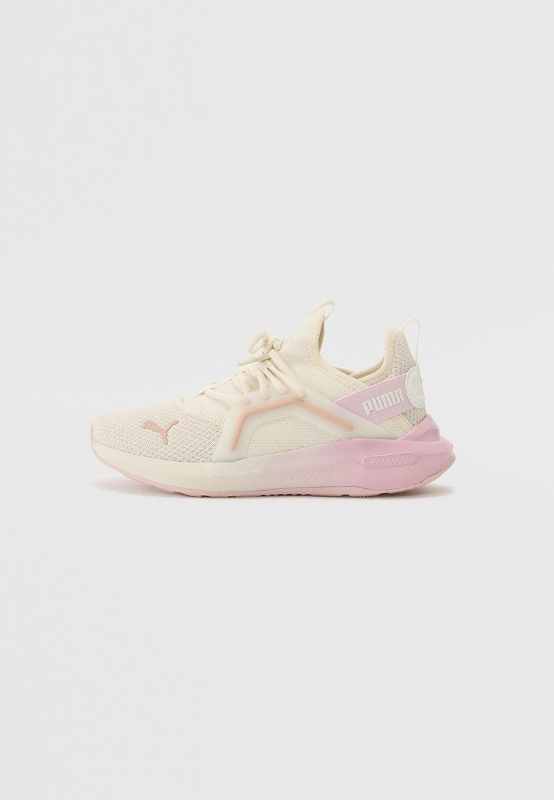 Light beige athletic shoe with a mesh upper, pink accents, and prominent Puma branding. Features a cushioned sole and laced design.