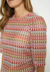 Colorful top featuring a textured pattern of pink, gold, and green stripes with puffed sleeves and a crew neckline.