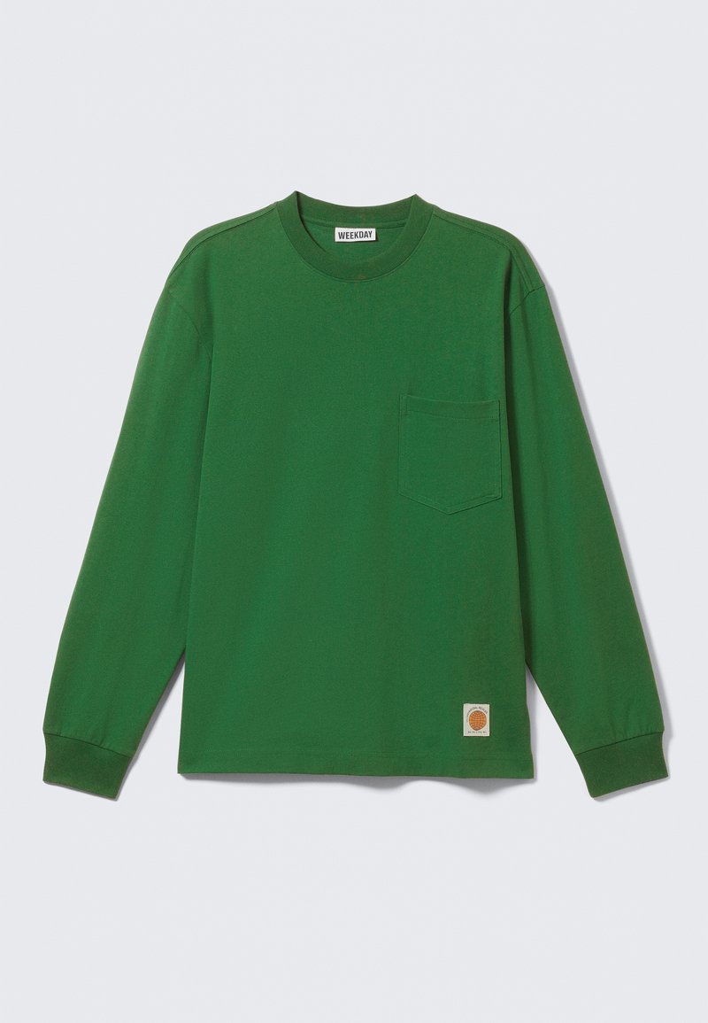 Long-sleeve, green cotton shirt with a crew neck, single chest pocket, and a small logo patch at the hem. Smooth texture, relaxed fit.