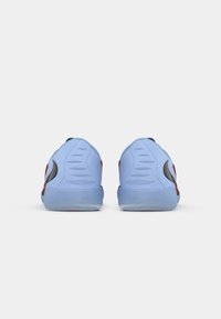 Blue athletic shoes with red accents and black detailing. Smooth material with a textured sole and molded heel for support.