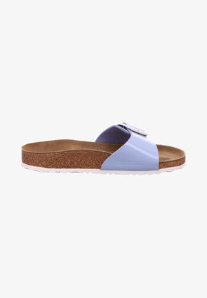 Blue synthetic slide sandal with a cork footbed and white outsole. Features a wide strap with a buckle for adjustable fit and a flat design.