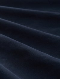 Tissu bleu marine avec une surface douce et texturée, présentant de subtiles vagues et plis qui indiquent de la profondeur et du mouvement.