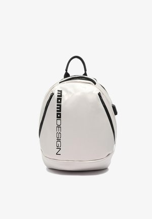 White rounded backpack with black vertical "Momo DESIGN" text, black zippers on sides, and black handle on top.