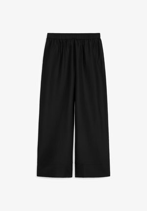 Pantalones negros de pierna ancha con cintura elástica y dobladillos remangados, extendidos sobre un fondo blanco.