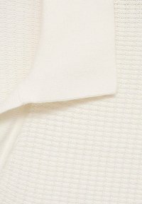White textured fabric with a ribbed design, featuring a flat, folded edge. Soft and smooth surface with a subtle sheen.