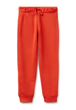 Jasnopomarańczowe spodnie dresowe z elastycznym pasem, regulowanym sznurkiem i ściągaczami przy kostkach, przedstawione na płasko na białym tle.
