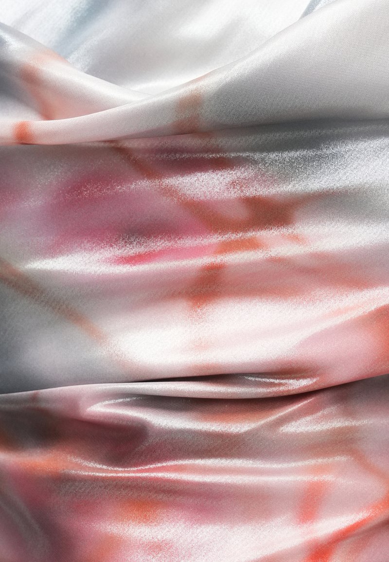Silky fabric with a smooth texture, features light gray base and abstract pink and red watercolor-like patterns.