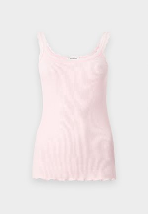 Light pink ribbed tank top with scalloped edges and adjustable straps. Soft texture, fitted design, and a straight hem at the bottom.
