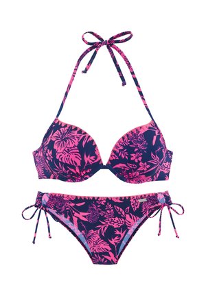 Navy blue bikini with pink tropical floral patterns, halter neck tie top, and side-tie bottoms on a white background.