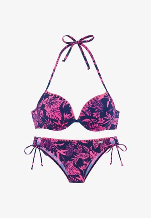 Navy blue bikini with pink tropical floral patterns, halter neck tie top, and side-tie bottoms on a white background.