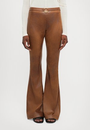Brown faux leather flared pants with a smooth texture, featuring a high waistband and a gold circular buckle at the belt.