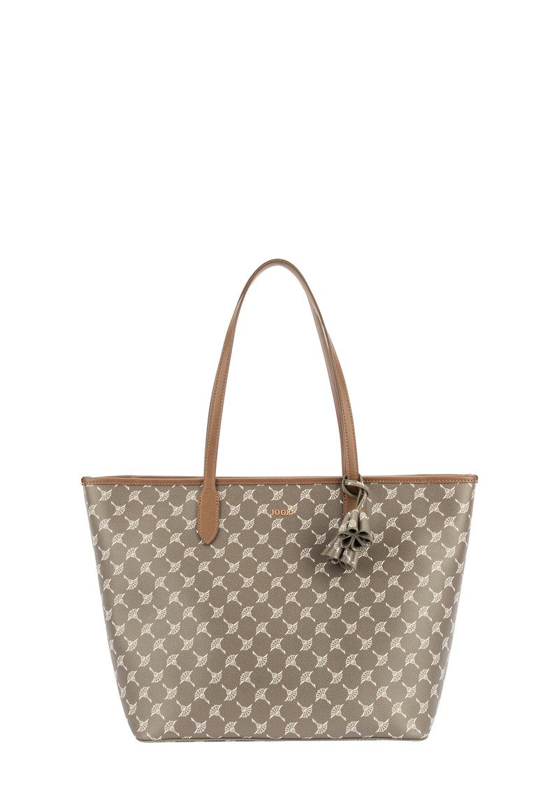 Beżowa torba jednolita z brązowymi skórzanymi uchwytami, wzorzysta tkanina z białymi wzorami oraz dekoracyjny akcent w postaci frędzli.