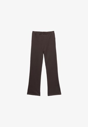 Brune, flagrende leggings lavet af blødt, strækbart stof med en elastisk talje. Ingen synlige mønstre eller hardware detaljer.