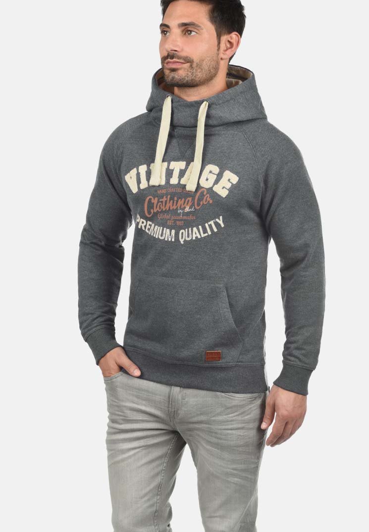 Gray hoodie with drawstrings, front pocket, and "Vintage Clothing Co" graphic. Features a ribbed hem and cuffs, made from a textured fabric.