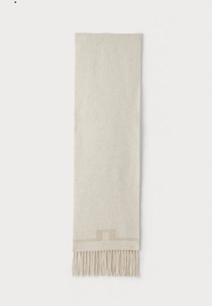 Bufanda beige hecha de una tela suave, con un sutil patrón geométrico cerca de los extremos y detalles en borlas. Forma rectangular, textura suave.