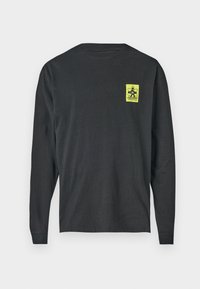 Black long-sleeve T-shirt made of cotton with a round neckline. Features a small, bright yellow graphic print on the left chest area.