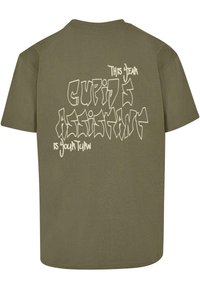 Olive green cotton t-shirt with short sleeves and a relaxed fit. Back features bold, stylized white text: "This Dear Cupid's Assistant Is Your Turn."