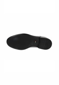 Semelle de chaussure noire avec une texture lisse, forme arrondie et petit talon. Comprend un logo en relief et un petit détail du drapeau italien.