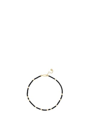 Sort og guldbelagt perlearmbånd med en guldlås og justerbar kæde på en hvid baggrund.