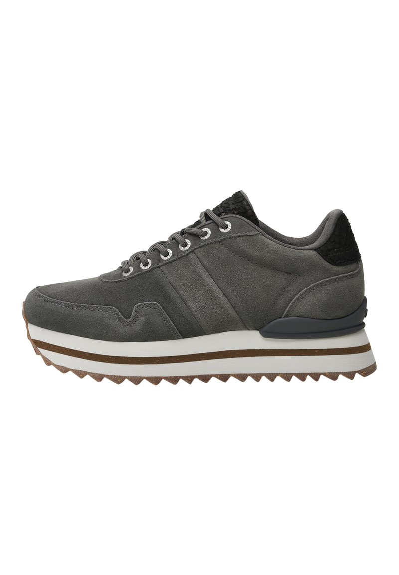 Gray suede sneaker with a textured black heel, white midsole, zigzag outsole, and silver eyelets. Features a streamlined design and subtle stripes.