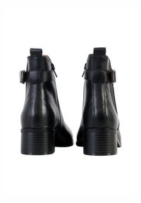 Black leather ankle boots with a smooth texture, rectangular heel, and adjustable strap detail at the back. Classic design for versatile wear.