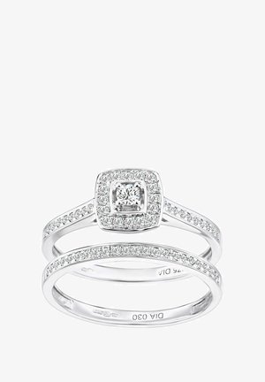 Zwei miteinander verbundene Ringe mit einem quadratischen Halo-Design. Gefertigt aus weißem Metall mit mehreren kleinen Diamanten um einen zentralen Stein.