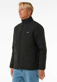 Black quilted jacket featuring a high collar, zipper closure, and a small logo accent on the chest. Casual fit and textured fabric.
