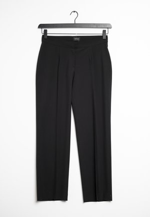 Black trousers with a straight-leg design, featuring a smooth texture, concealed waistband, and subtle front pleats. Hanging on a black hook.