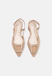 Beige slingback heels with pointed toe, textured fabric, adorned with a square crystal accent on the vamp, and ankle strap for support.