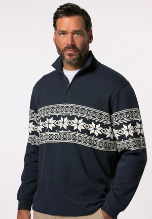 Marine blauwe pullover met hoge kraag, voorzien van een wit sneeuwvlokpatroon op de borst, geribbelde manchetten en een half-rits voorzijde.