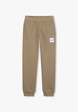 Pantalon de survêtement marron clair fuselé avec taille et poignets élastiques, poches latérales, et un patch blanc portant l'inscription "BOSS" sur la cuisse droite.