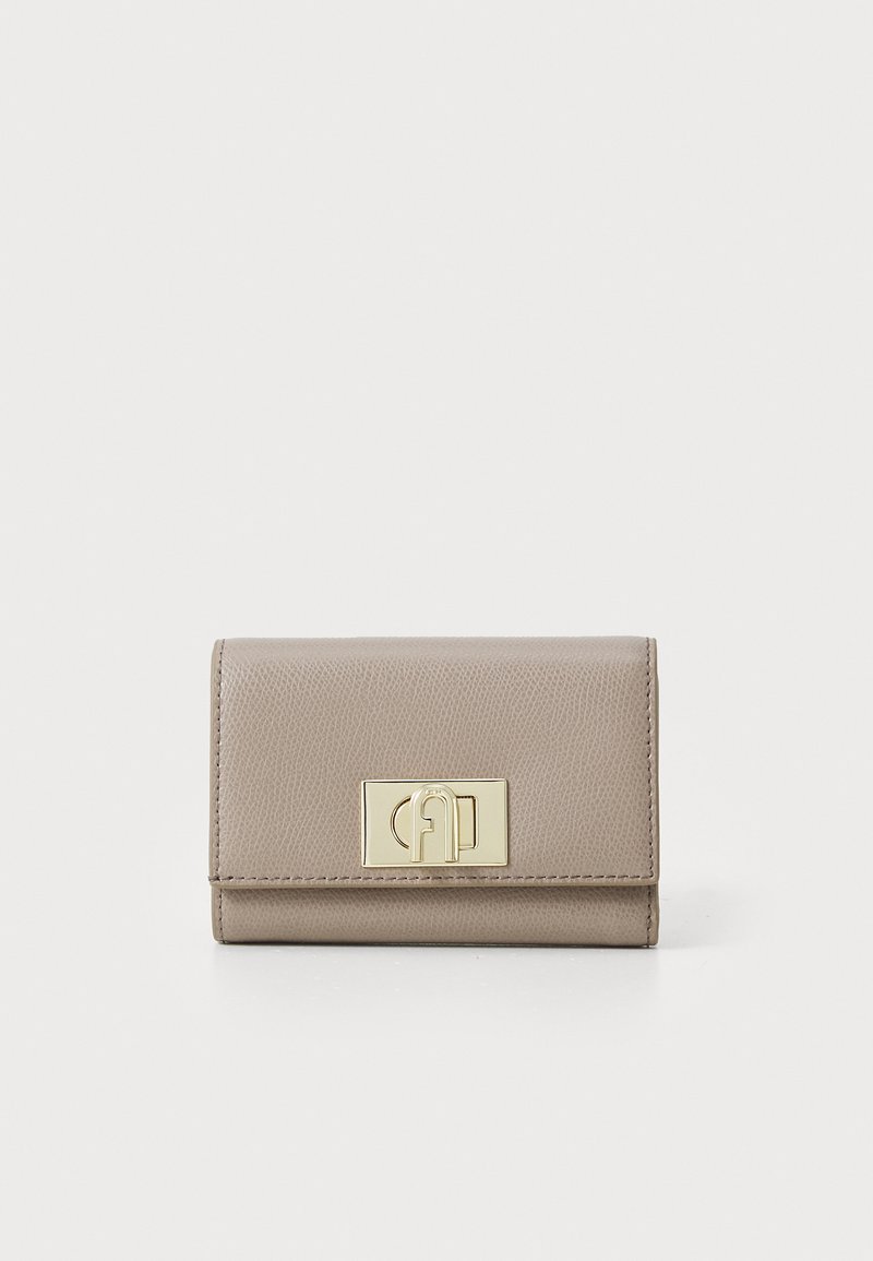 Compact beige leather wallet with a textured finish, featuring a gold metal clasp and a sleek fold-over design.