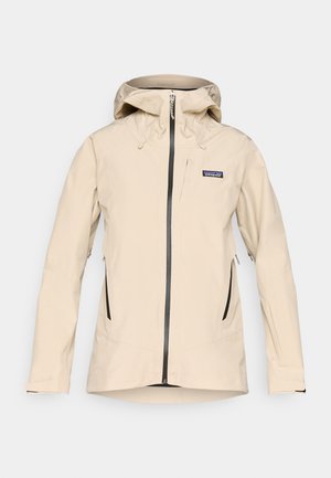 Bēša ūdenizturīga jaka ar kapuci, priekšējo rāvējslēdzēju un divām sānu kabatām ar rāvējslēdzējiem. Satur elastīgus piedurknes un nedaudz izliekta apakšmalu.