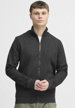 Dark gray zip-up sweatshirt with a high collar, ribbed cuffs, and side pockets. Features a contrasting zipper pull with a wooden accent.