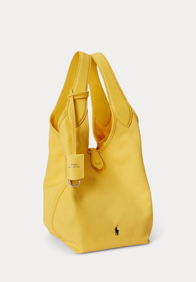 Gul læder- og lærredsnettaske med dobbelt håndtag, Polo Ralph Lauren-logo og lille metalringdetalje på remmen.