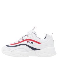 White sneaker with red and navy accents. Features a rounded toe, chunky sole, textured panels, and a branded logo on the side.