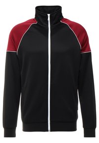 Giacca nera con zip, pannelli sulle spalle bordeaux, dettaglio in piping bianco e colletto alto. Realizzata in tessuto morbido e elasticizzato per il massimo comfort.