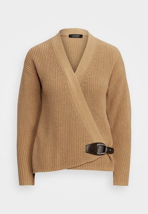 Beige gebreide omslagtrui met lange mouwen en een donkerbruine leren gesp aan de zijkant.
