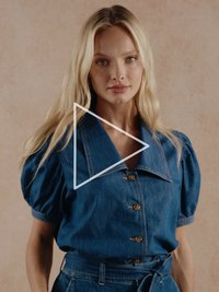 Jeansbluse mit weitem Kragen, kurzen Puffärmeln und durchgehender Knopfleiste. Verfügt über einen Taillengürtel und ist in Blau mit dezenten Nahtdetails gehalten.