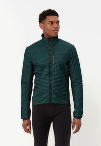Giacca imbottita verde scuro con collo alto, pannelli laterali neri e zip frontale completa. Presenta una texture trapuntata nella zona del petto.