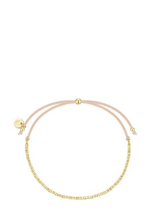 Nastaviteľný náramok s svetloružovým povrazom a zlatým kovovým reťazcom. Obsahuje malý okrúhly prívesok s logom a posuvnú korálku na úpravu veľkosti.