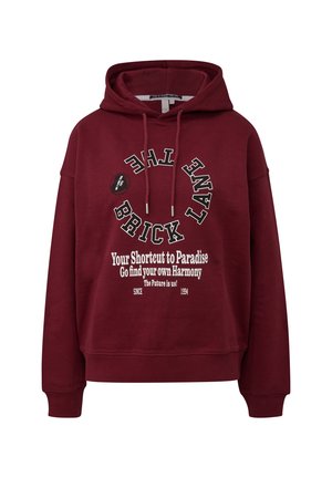 Bordeauxrote Kapuzenpullover mit weißem Text "The Brick Lane" in einem Kreis und "Your Shortcut to Paradise, Go find your own Harmony" auf der Vorderseite.