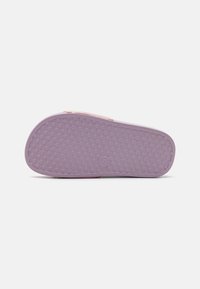 Light pink rubber sandal sole featuring a star-patterned texture and rounded shape, with a smooth finish and slight curvature at the edge.