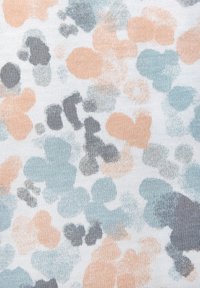 Textile with a white background featuring a pattern of irregular shapes in soft peach, teal, and gray tones, creating a subtle, textured appearance.