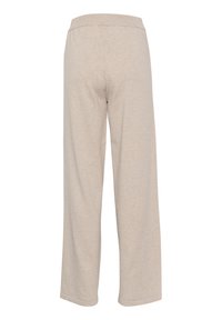 Ljusbeige vida byxor gjorda av mjukt tyg, med elastisk midja och en slät yta utan synliga mönster eller dekorationer.