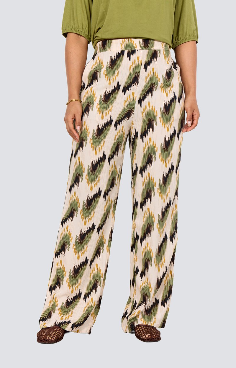 Wide-leg pants in a cream base featuring a green, black, and yellow abstract pattern. Textured fabric with pleats and side pockets.